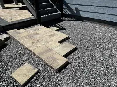 Setting rectangular pavers by hand on the prepared base