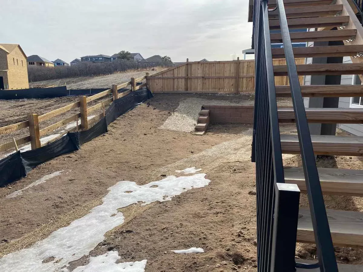 Sloped side yard before landscape installation