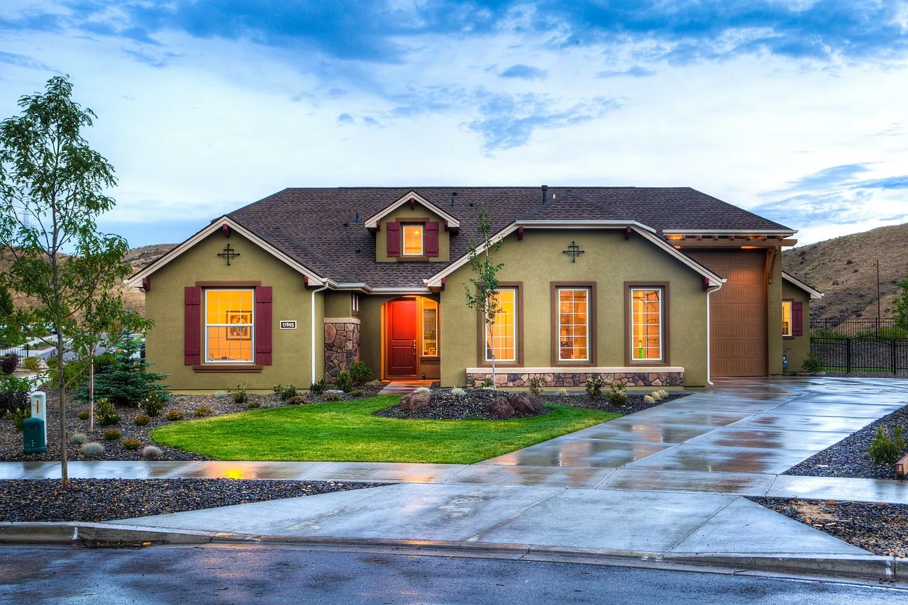 Residential concrete driveway with broom texture, defined control joints, and a connected front walkway