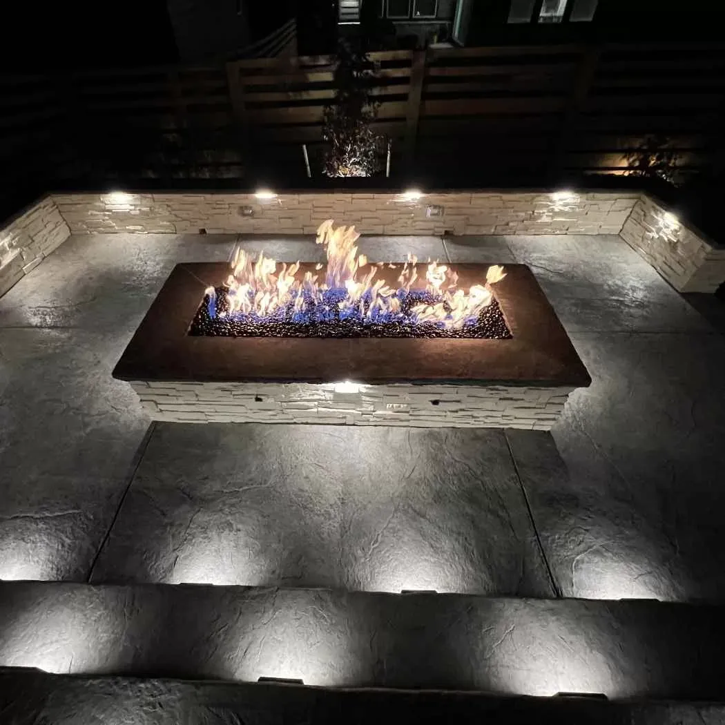Built-in fire pit with a stone seating area