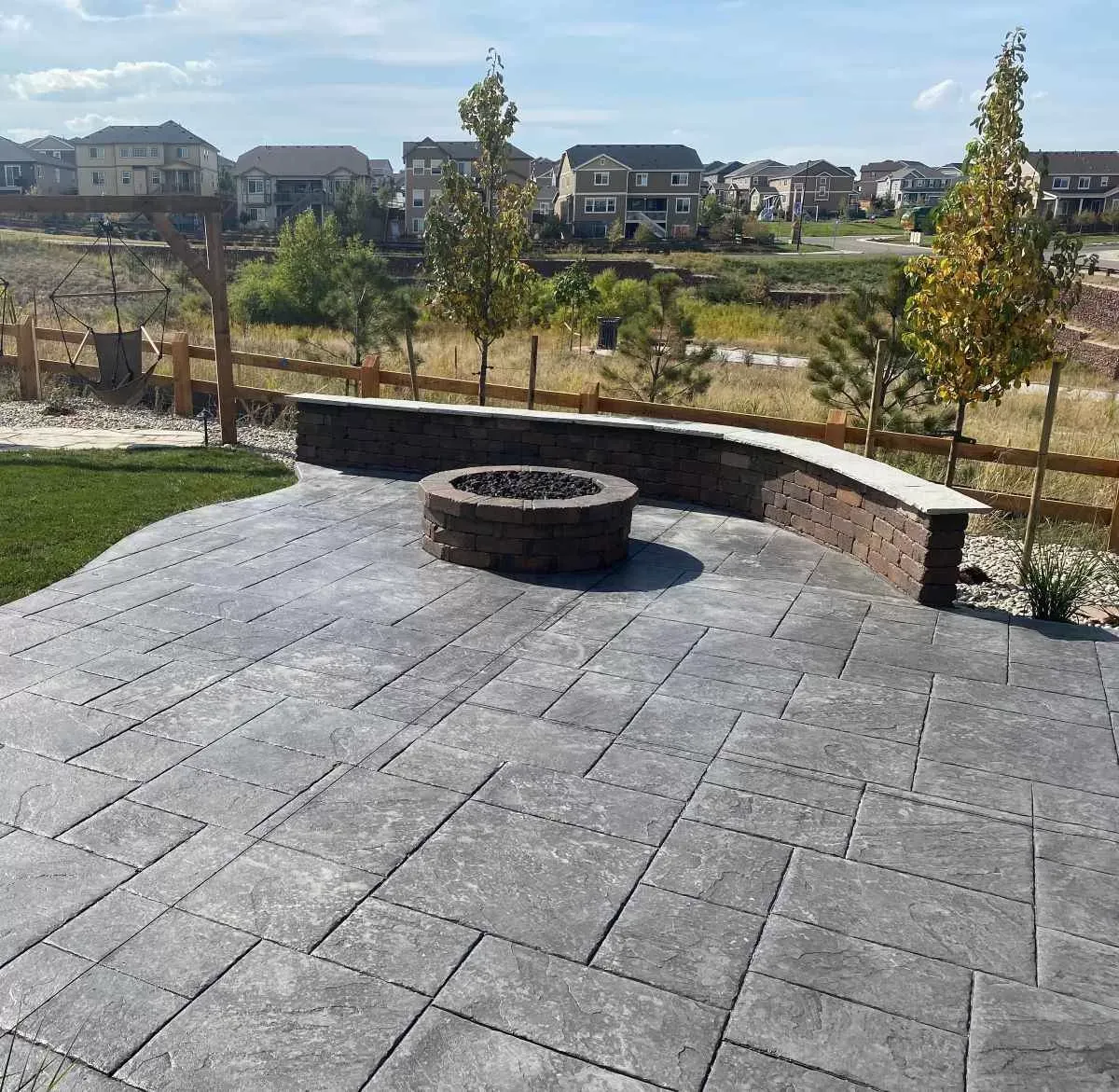 Stamped concrete patio with curved seating wall