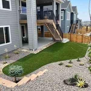 Pristine artificial turf installation in a Castle Pines backyard, complementing modern home architecture.